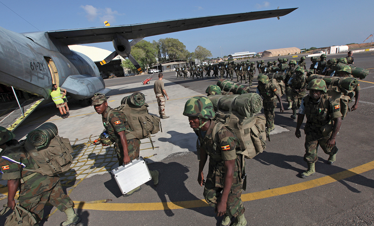 Members of the EASB from Uganda queue to board a French tactical aircraft C160 Transall at the French Air Base 188 in Djibouti