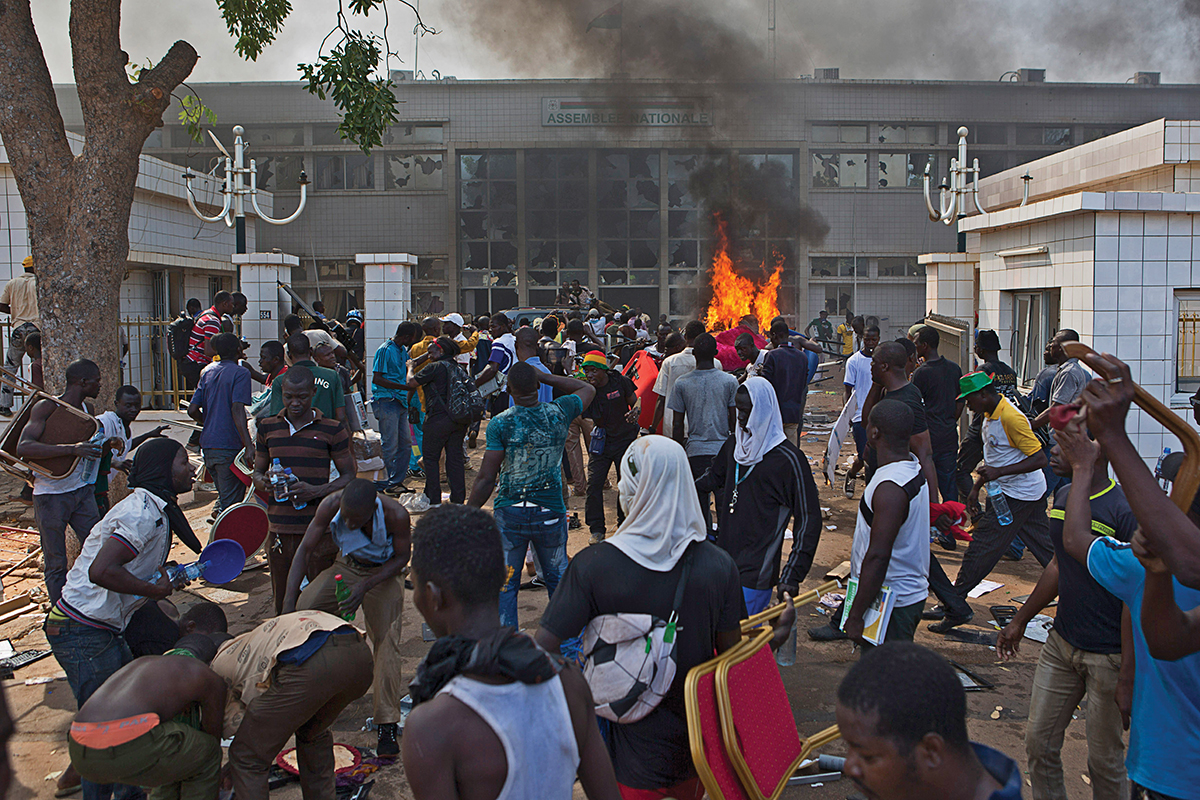 Anti-government protesters set fire to the parliament building in Ouagadougou