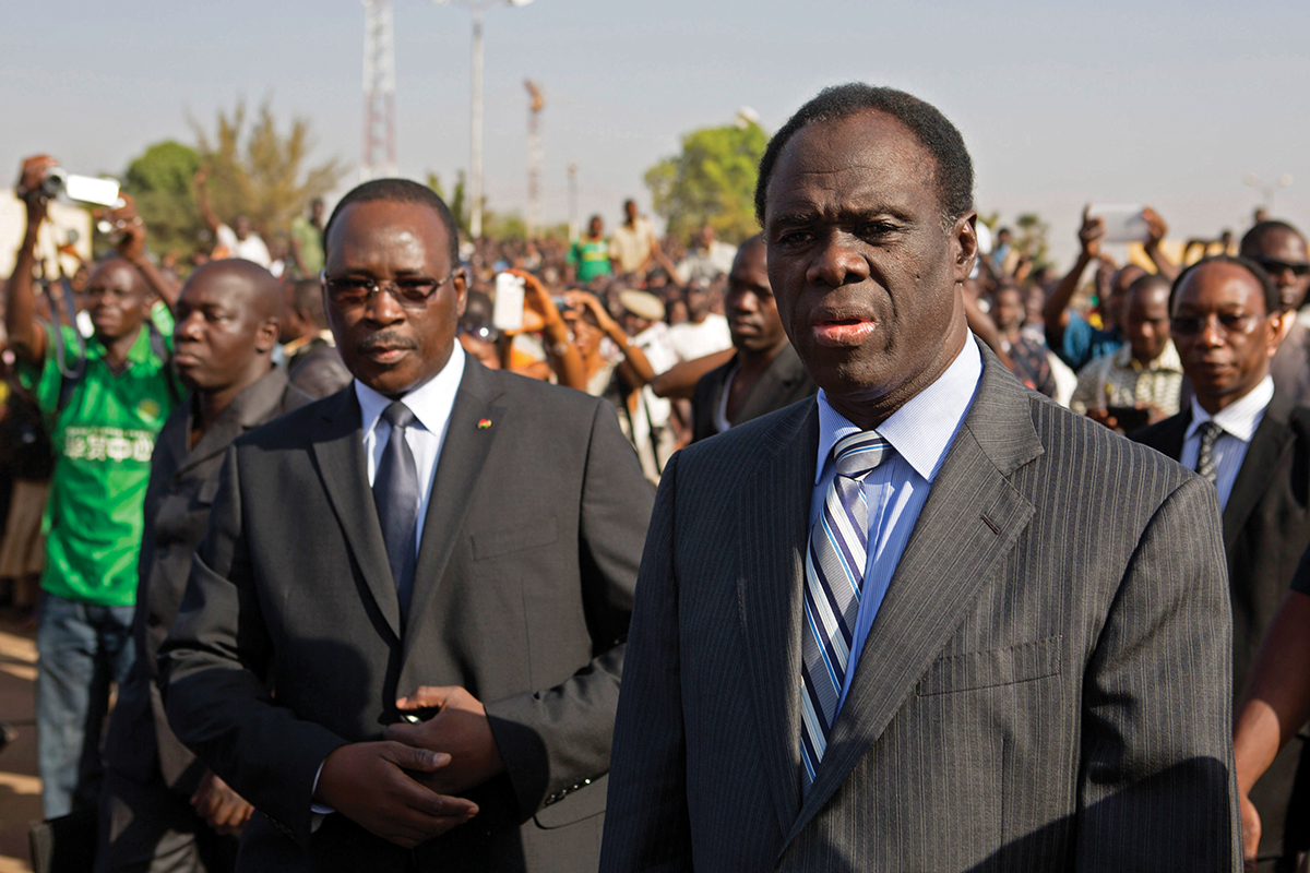 Burkina Faso President Michel Kafondo and PM Isaac Zida arrive at a memorial service for six people who died during the recent popular uprising in Ouagadougou