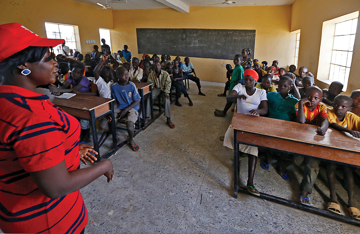 Children displaced as a result of Boko Haram attacks in the northeast region of Nigeria, attend class at Maikohi secondary school inside a IDP camp in Yola