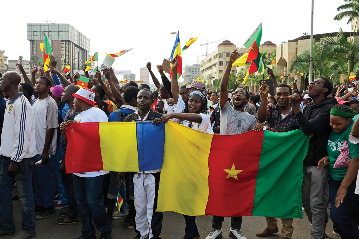 People holding Chadian and Cameroonian flags